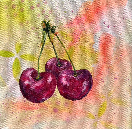 3 juicy red cherries on loose abstract background